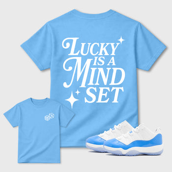 Lucky Is a Mindset front and back graphic t-shirt styled to complete your outfit with the11s UNC, shown in Carolina Blue.