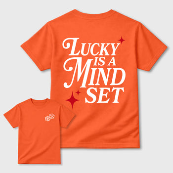 Lucky Is a Mindset graphic t-shirt styled to complete your sneaker outfit with the sneakers, shown in Orange.