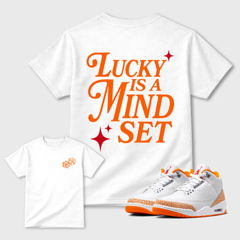 Lucky Is a Mindset graphic t-shirt styled to complete your sneaker outfit with the Air Jordan 3 Orange Citrus sneakers, shown in White.