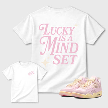 Lucky Is a Mindset graphic t-shirt styled to complete your sneaker outfitwith the AJ4 Iced Carmine, shown in White.
