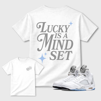 Lucky Is a Mindset front and back graphic t-shirt styled to complete your outfit with theAir Jordan 5 White Metallic sneakers, shown in White.