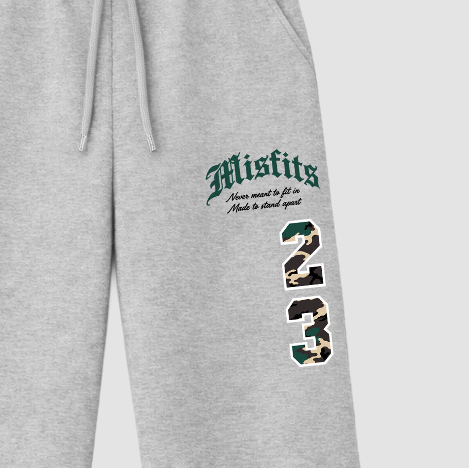 Misfits 23 graphic wide cut sweatpants designed to match the Air Foamposite Pro Green Camo, featuring coordinated Heather Grey 2 options for a perfect streetwear vibe.