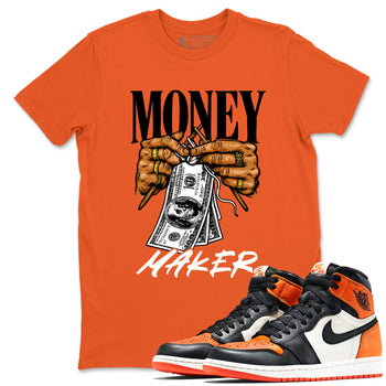 Money Maker sneaker match t-shirt styled to complete your fit with the Air Jordan 1 Shattered Backboard sneakers, shown in Orange 1.