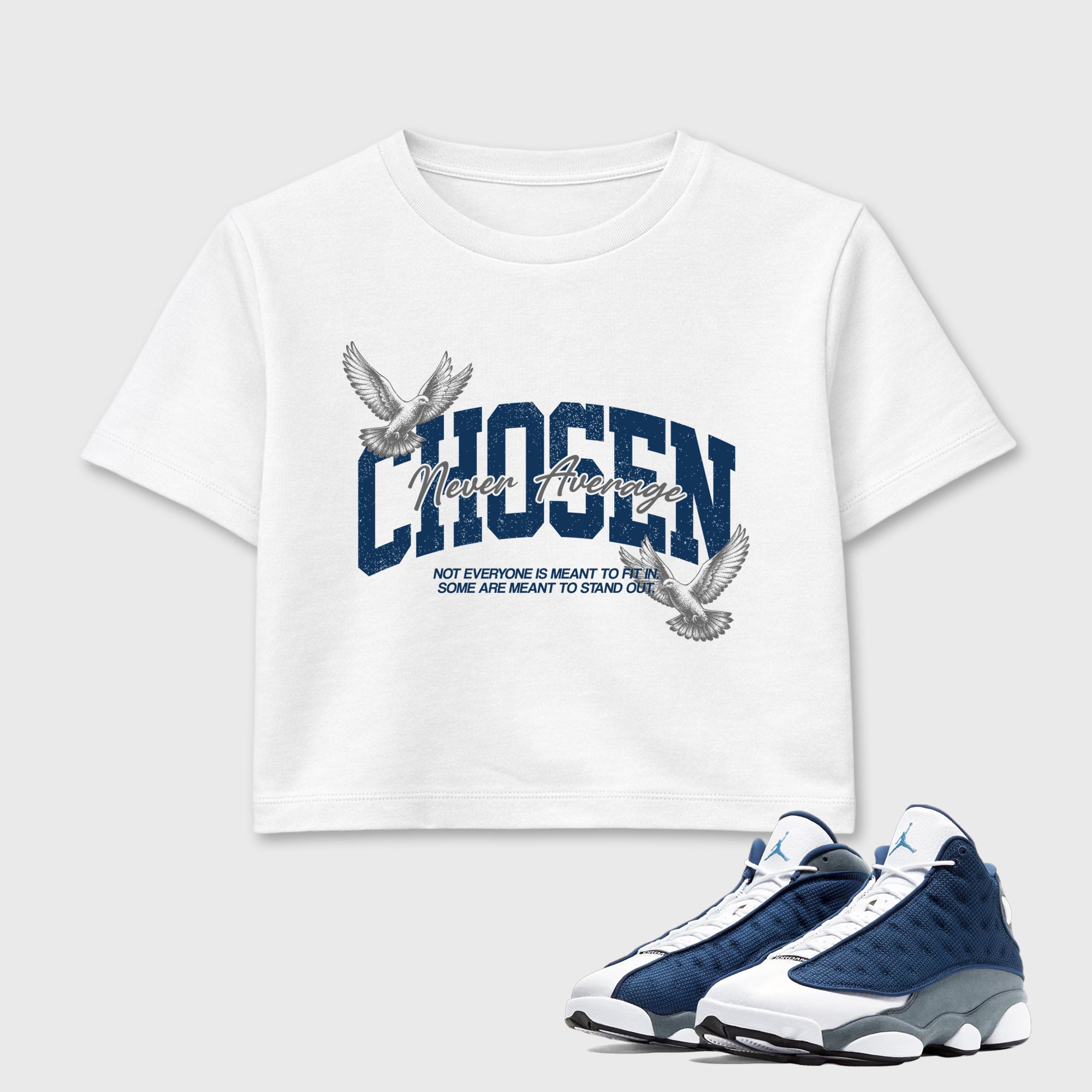 Never Average women’s crop tee designed to match the Air Jordan 13 Flint, featuring coordinated White 1 options for a perfect streetwear vibe.