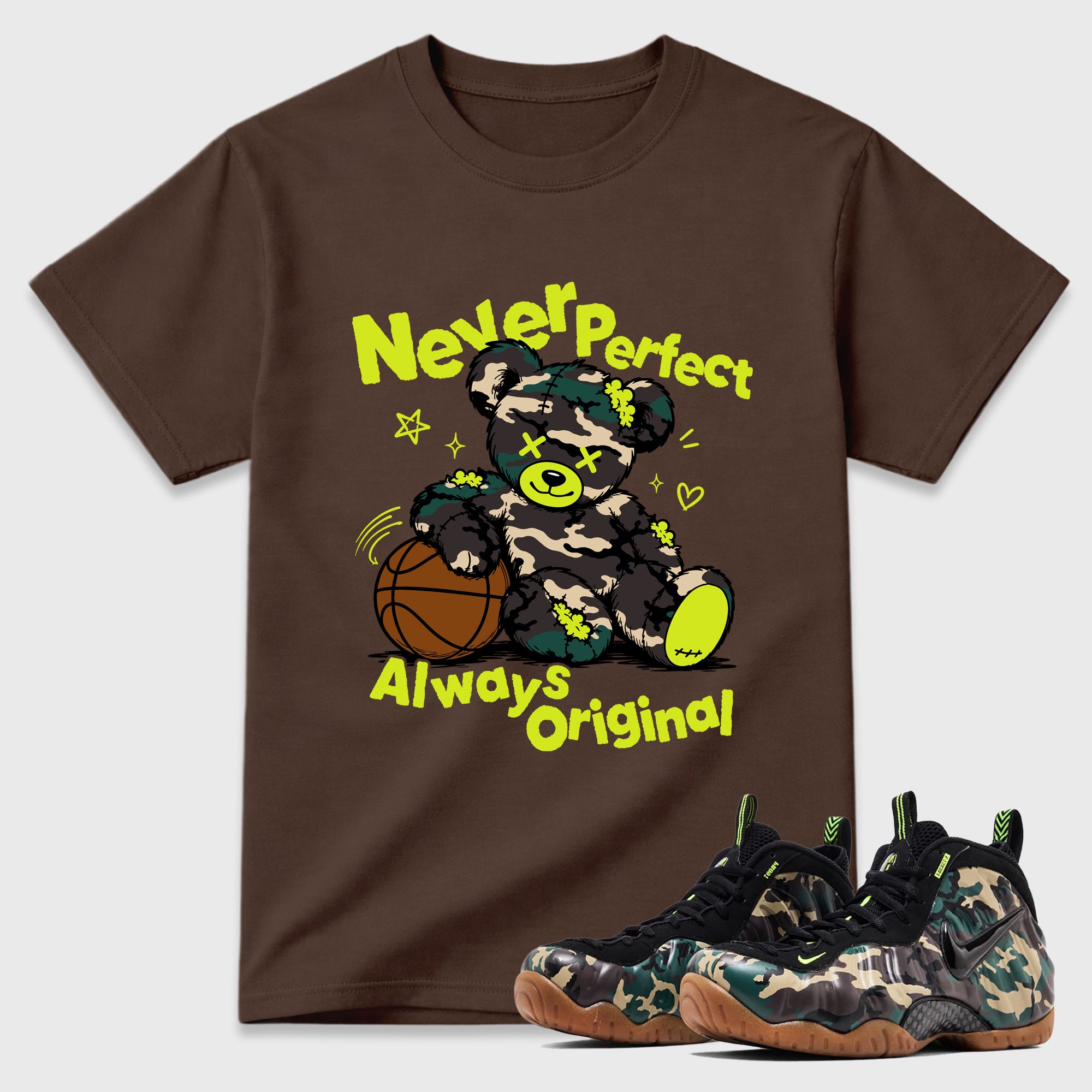 Never Perfect Always Original Graphic T-Shirt featuring original streetwear artwork designed to match the Air Foamposite Pro Green Camo. Dark Chocolate 1 Graphic T-Shirt.