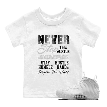 Never Stop The Hustle baby and kids t-shirt crafted for little sneakerheads to shine with the Air Foamposite One Triple White sneakers, displayed in White 1.