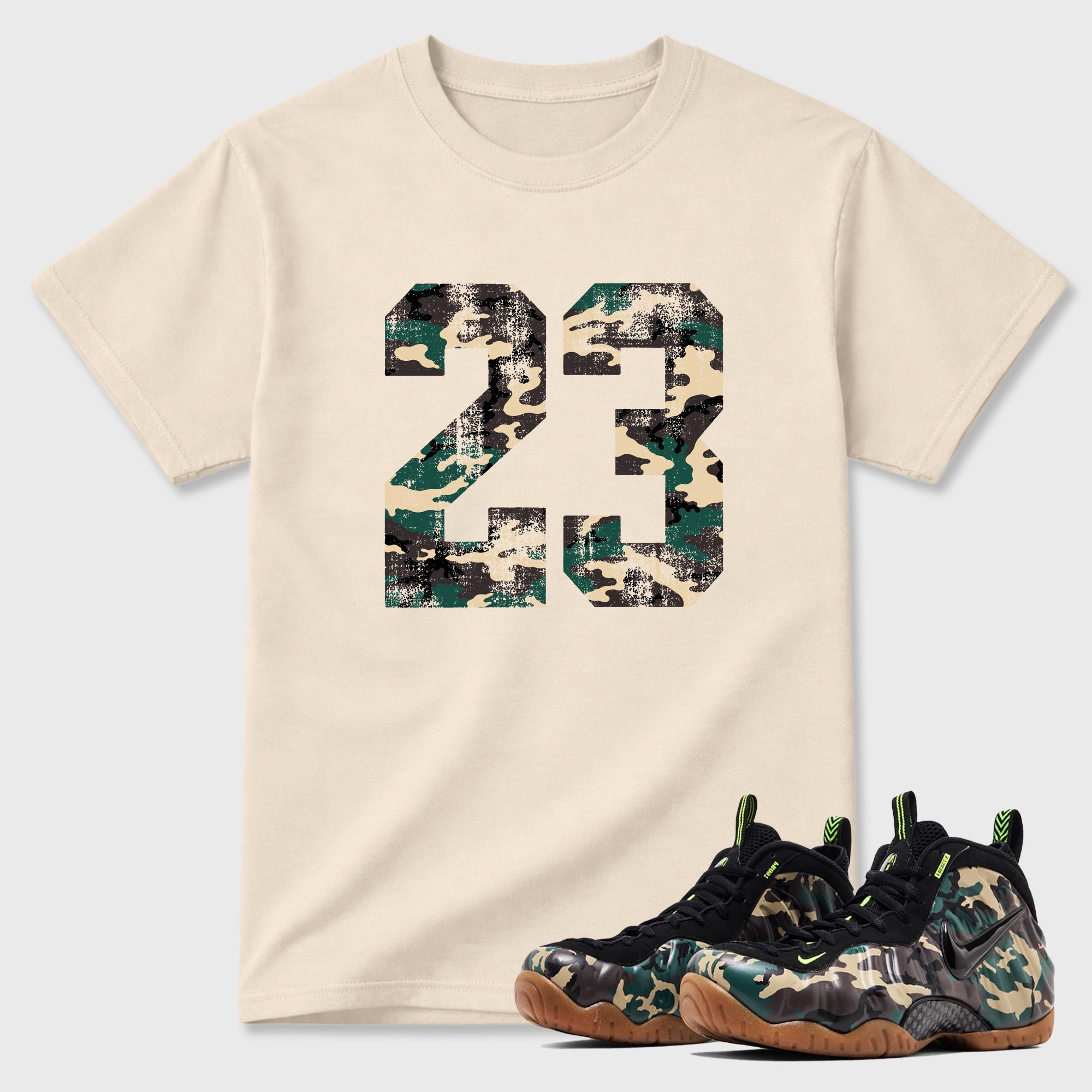 No.23 Graphic T-Shirt featuring original streetwear artwork designed to match the Air Foamposite Pro Green Camo. Natural 1 Graphic T-Shirt.