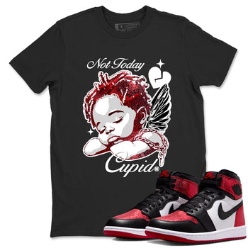 Not Today Cupid sneaker match t-shirt styled to complete your fit with the Air Jordan 1 Ruby sneakers, shown in Black 1.