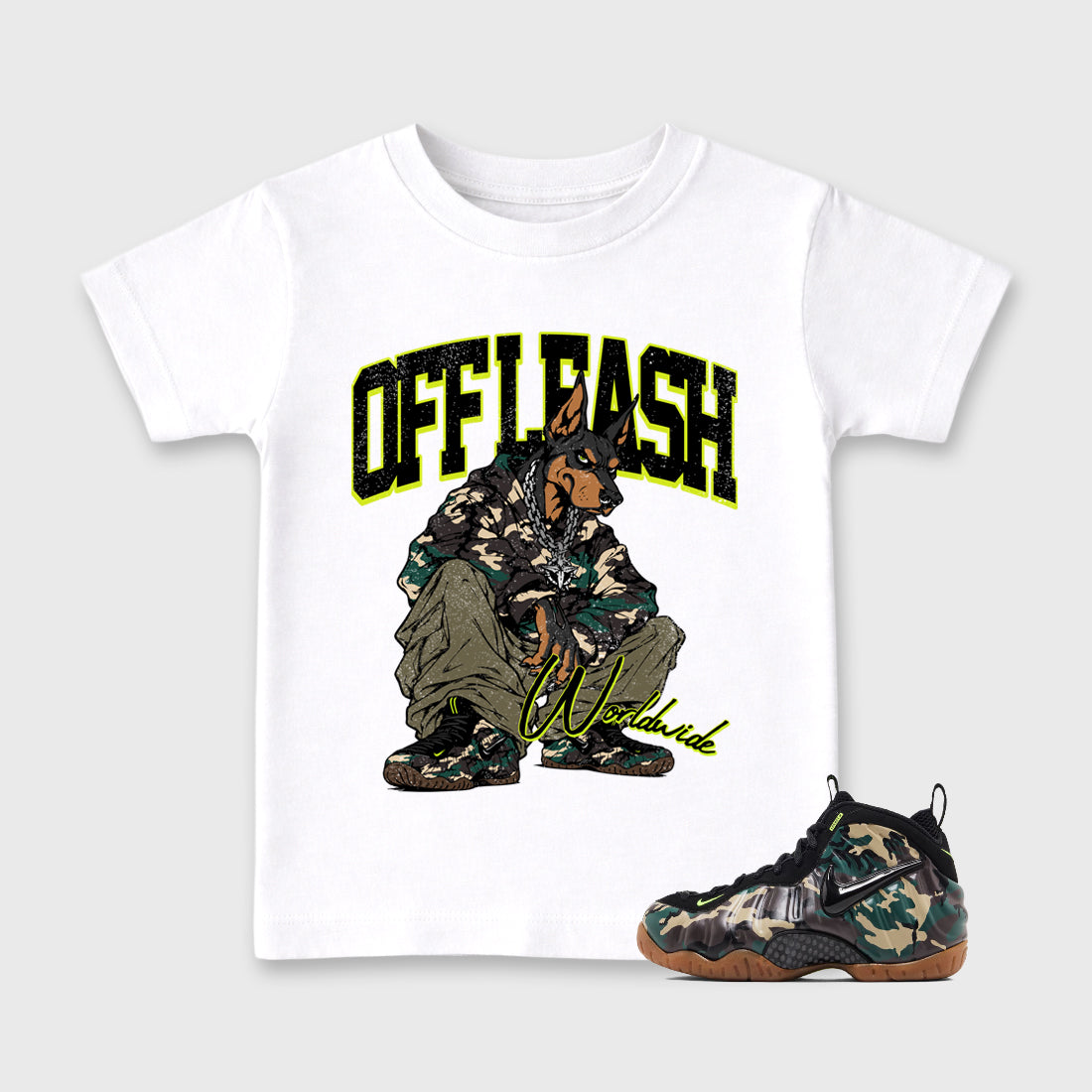 Off Leash Baby & Kids Graphic T-Shirt featuring original artwork designed to match the Air Foamposite Pro Green Camo. White 1 Kids Graphic Tee.