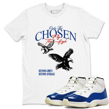 White t-shirt with eagle design and text, paired with blue and white sneakers.