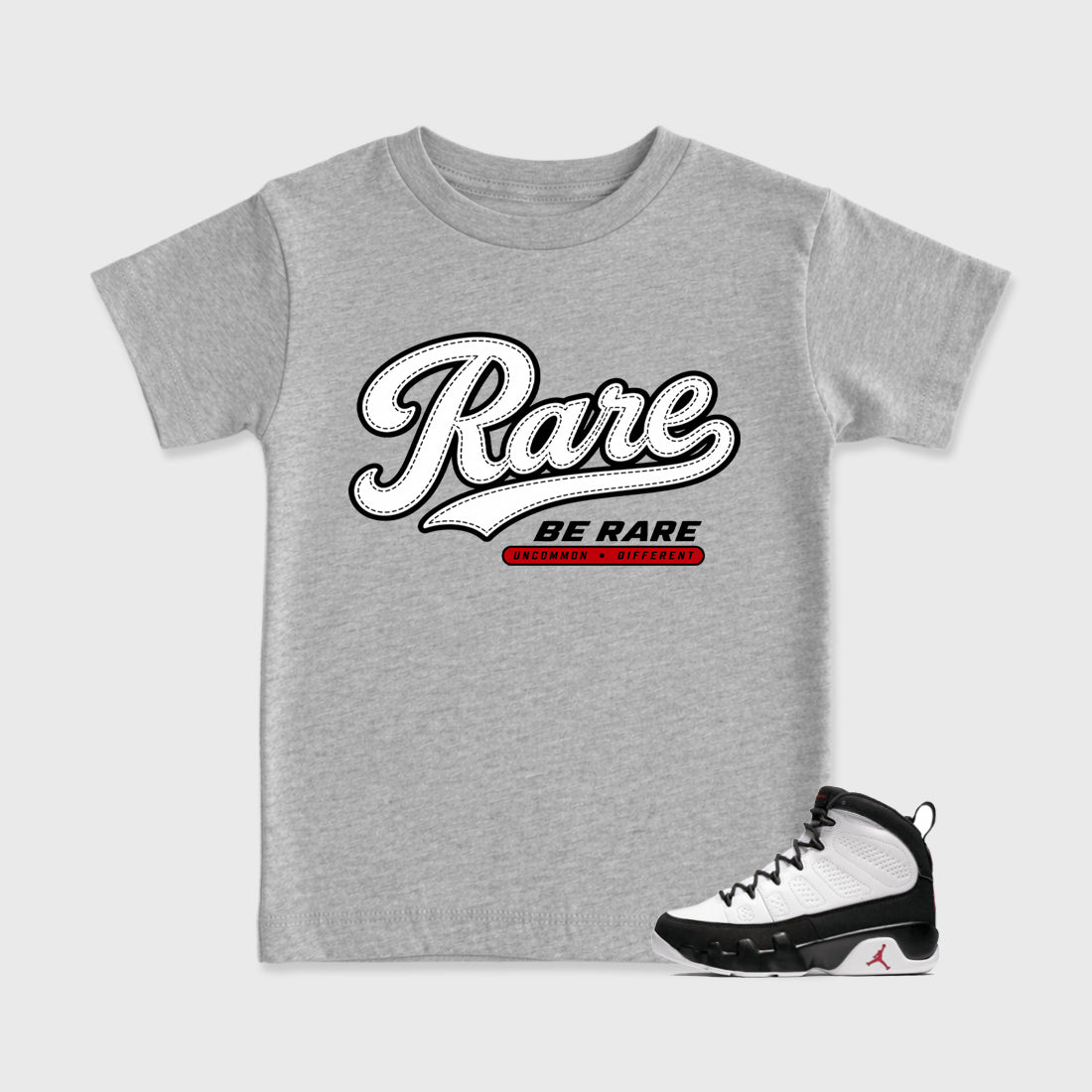 Rare Baby & Kids Graphic T-Shirt featuring original artwork designed to match the Air Jordan 9 True Red. Heather Grey 1 Kids Graphic Tee.