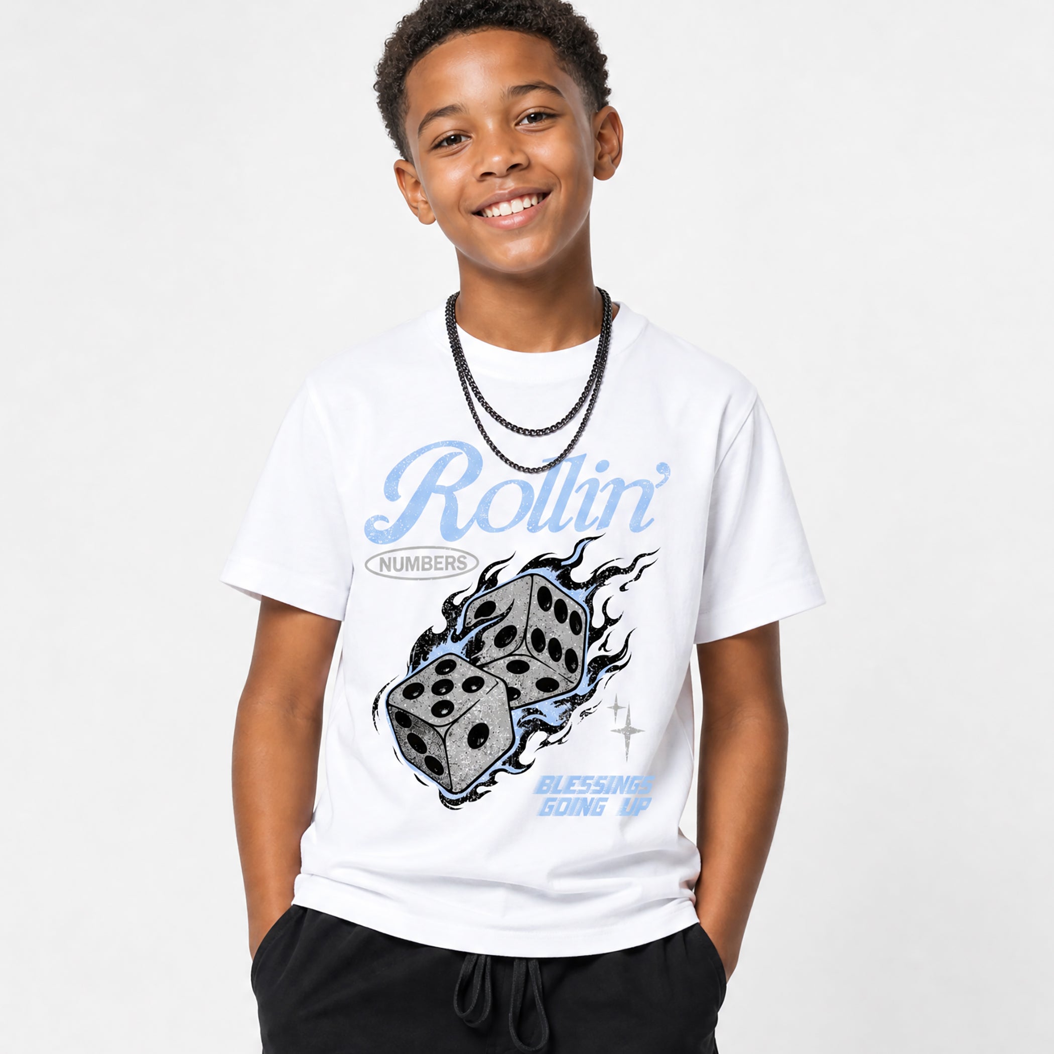Child wearing a white t-shirt with rollin dice design and text on a plain background