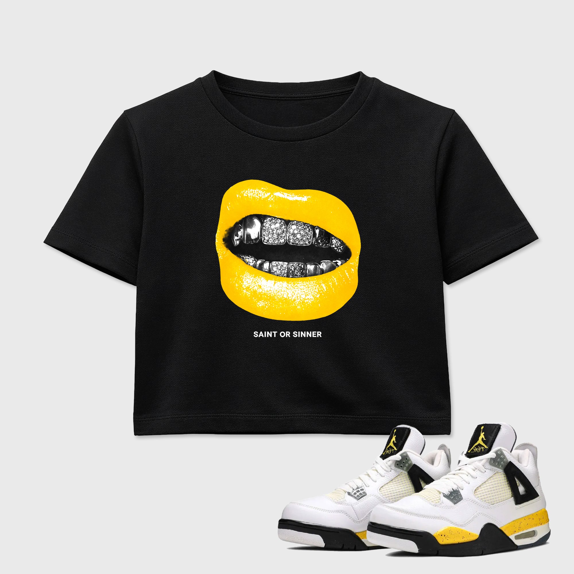 Saint or Sinner women’s crop tee designed to match the Air Jordan 4 Tour Yellow, featuring coordinated Black 1 options for a perfect streetwear vibe.