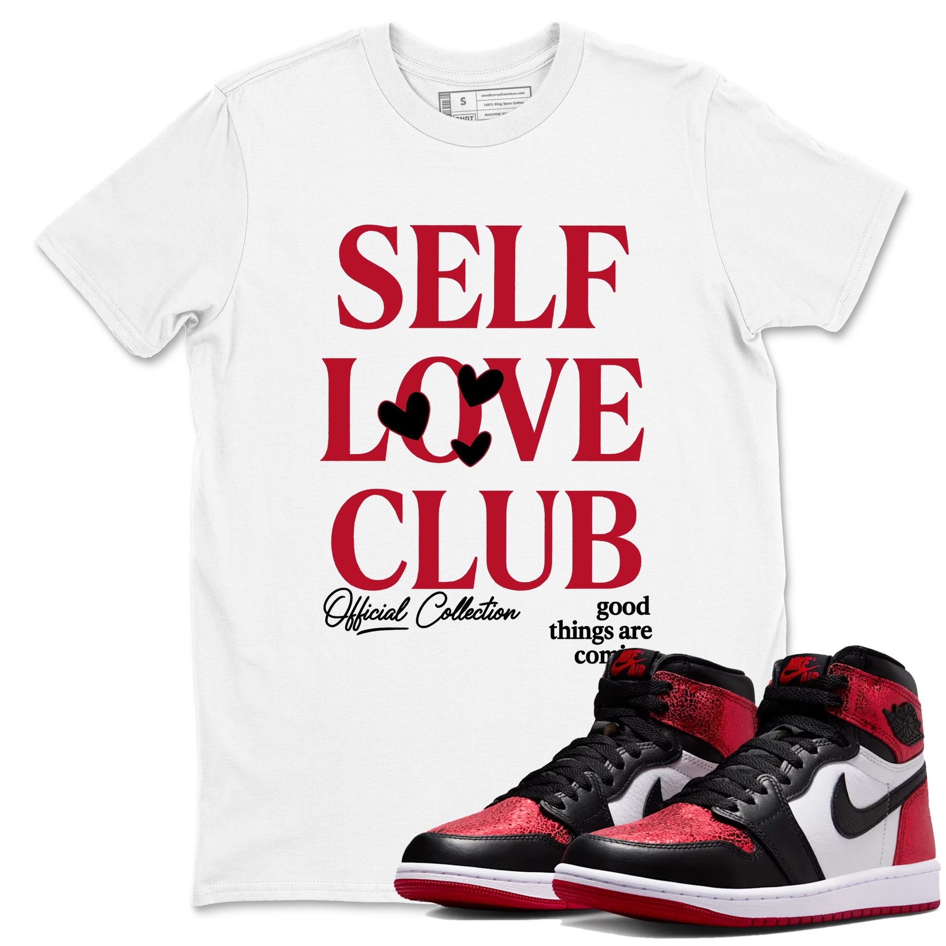 Self Love Club sneaker match t-shirt styled to complete your fit with the Air Jordan 1 Ruby sneakers, shown in White 1.