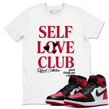 Self Love Club sneaker match t-shirt styled to complete your fit with the Air Jordan 1 Ruby sneakers, shown in White 1.