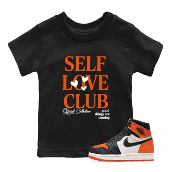 Self Love Club baby and kids t-shirt crafted for little sneakerheads to shine with the Air Jordan 1 Shattered Backboard sneakers, displayed in Black 1.