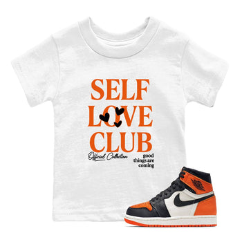 Self Love Club baby and kids t-shirt crafted for little sneakerheads to shine with the Air Jordan 1 Shattered Backboard sneakers, displayed in White 1.