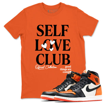 Self Love Club sneaker match t-shirt styled to complete your fit with the Air Jordan 1 Shattered Backboard sneakers, shown in Orange 1.