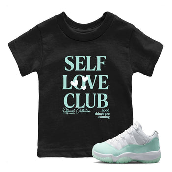 Self Love Club baby and kids t-shirt crafted for little sneakerheads to shine with the Air Jordan 11 Igloo sneakers, displayed in Black 1.