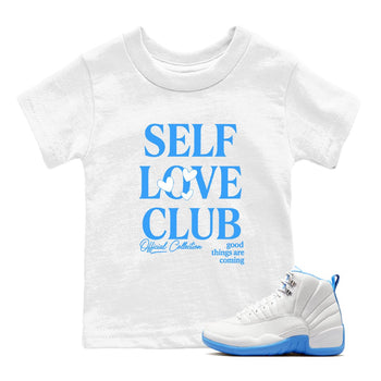 Self Love Club baby and kids t-shirt crafted for little sneakerheads to shine with the Air Jordan 12 White and University Blue sneakers, displayed in White 1.