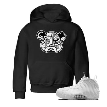 Sneaker Bear Face baby and kids t-shirt crafted for little sneakerheads to shine with the Air Foamposite One Triple White sneakers, displayed in Black 1.