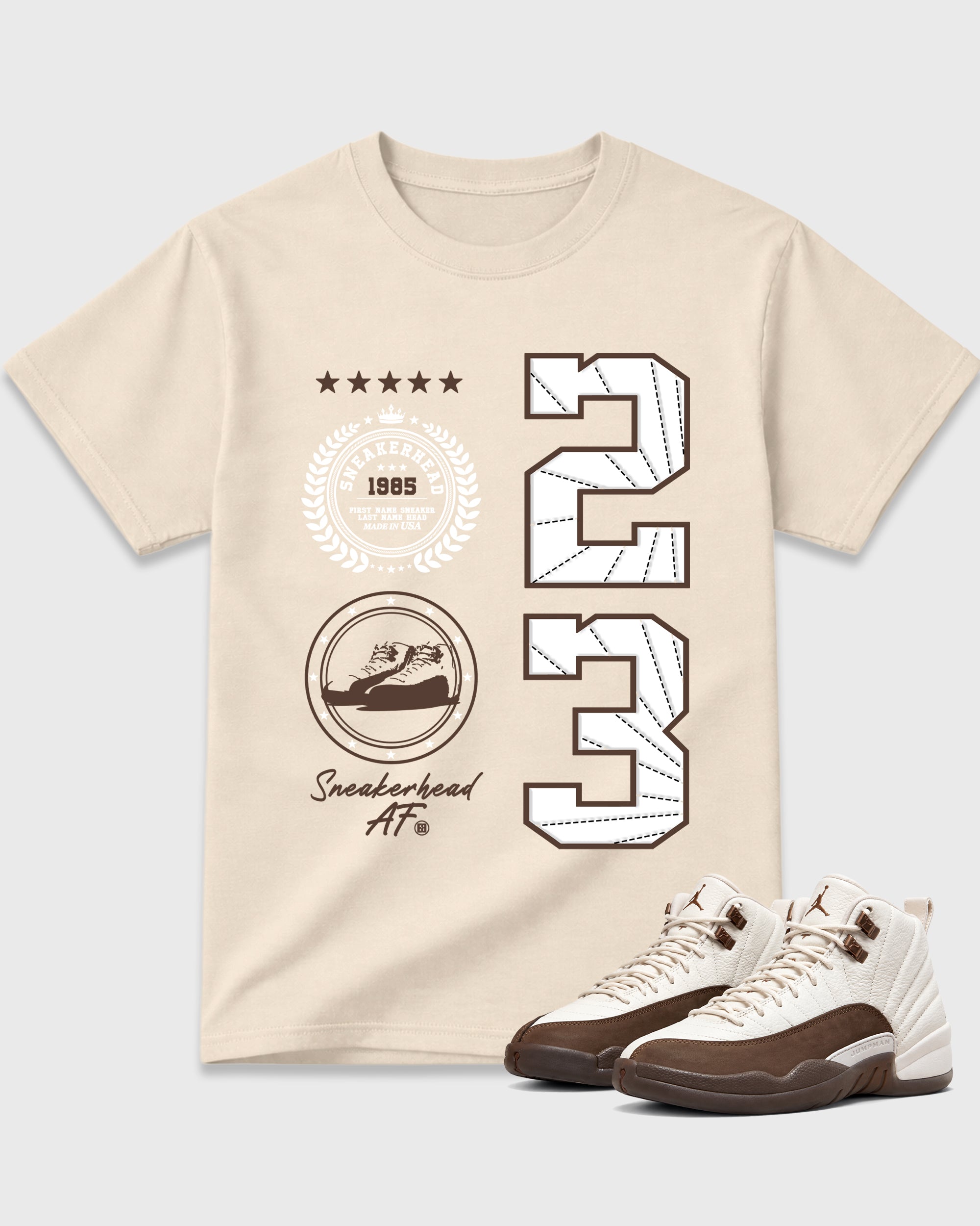 Sneaker Emblem Graphic T-Shirt featuring original streetwear artwork designed to match the Air Jordan 12 Fireside. Natural 1 Graphic T-Shirt.