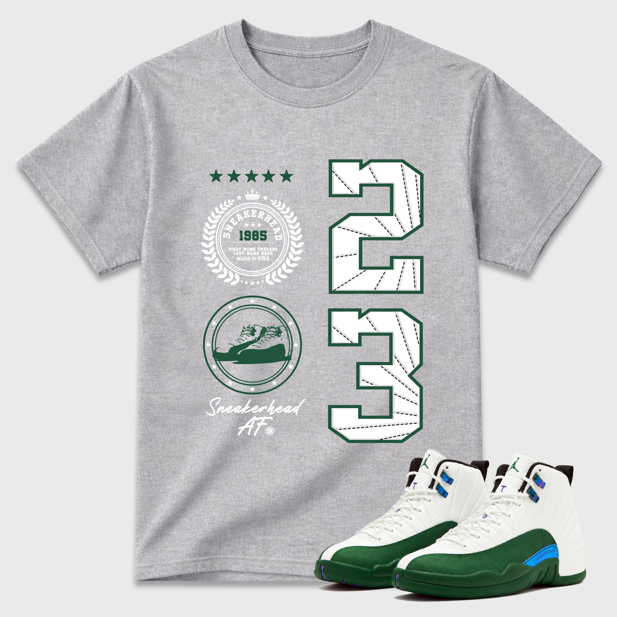 Sneaker Emblem Graphic T-Shirt featuring original streetwear artwork designed to match the Air Jordan 12 Summit Green. Heather Grey 1 Graphic T-Shirt.
