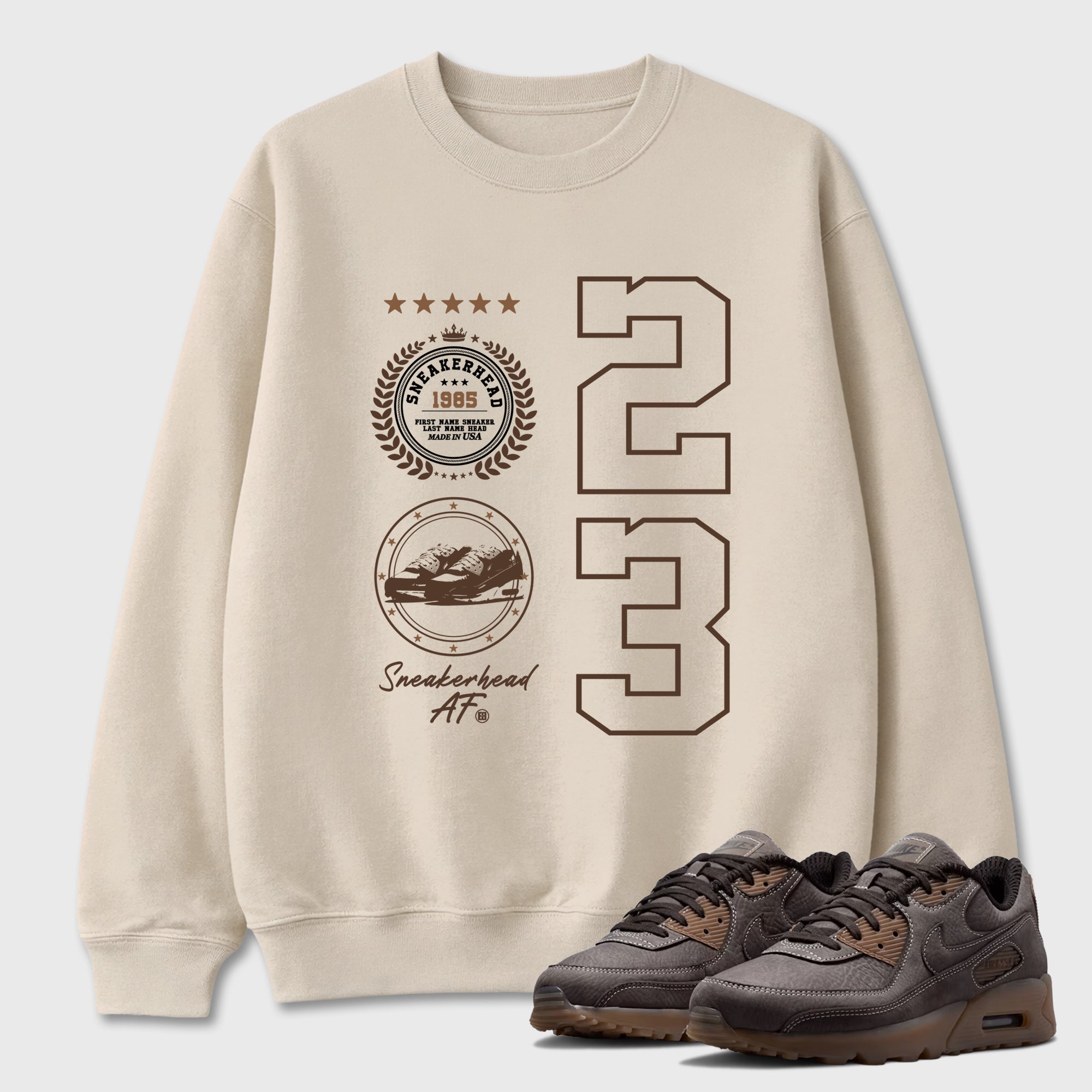 Sneaker Emblem Graphic T-Shirt featuring original streetwear artwork designed to match the Air Max 90 Shadow Brown. Natural 1 Graphic Tee.