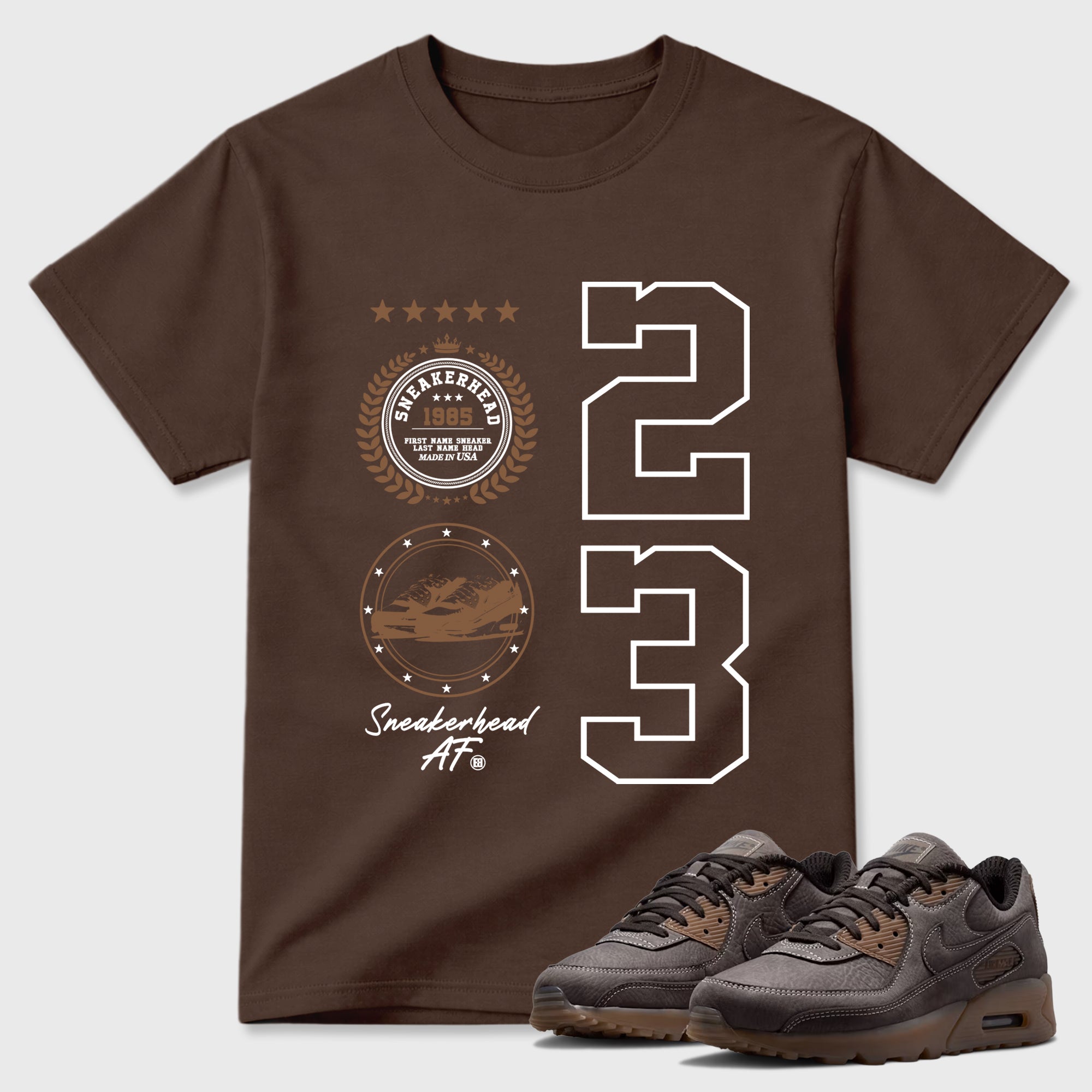 Sneaker Emblem Graphic T-Shirt featuring original streetwear artwork designed to match the Air Max 90 Shadow Brown. Dark Chocolate 1 Graphic T-Shirt.