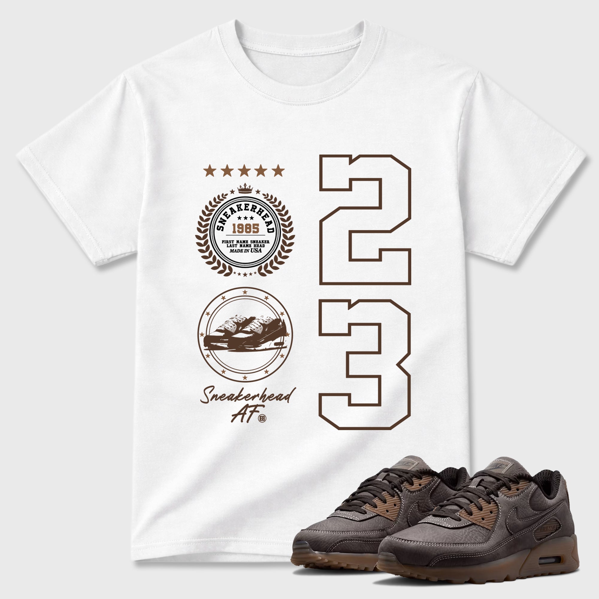 Sneaker Emblem Graphic T-Shirt featuring original streetwear artwork designed to match the Air Max 90 Shadow Brown. White 1 Graphic T-Shirt.