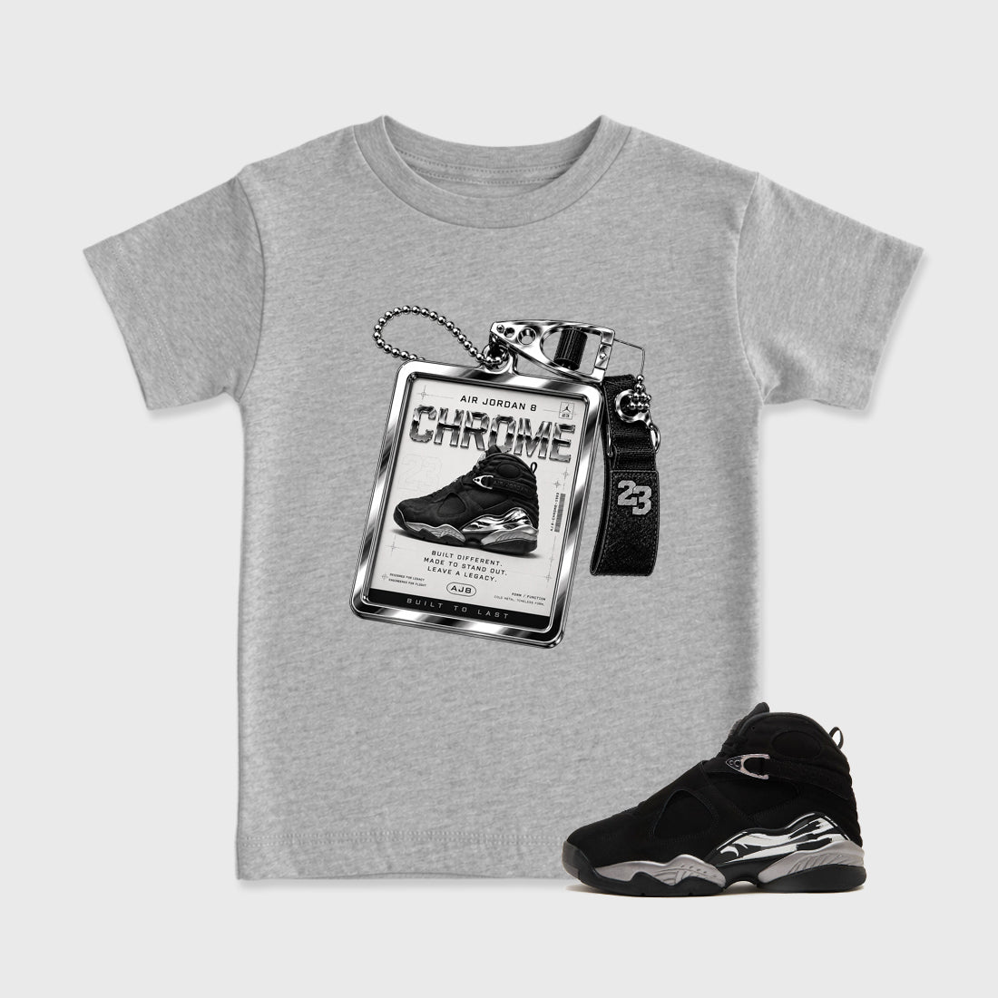 Sneaker Hang Tag Baby & Kids Graphic T-Shirt featuring original artwork designed to match the Air Jordan 8 Chrome. Heather Grey 1 Kids Graphic Tee.