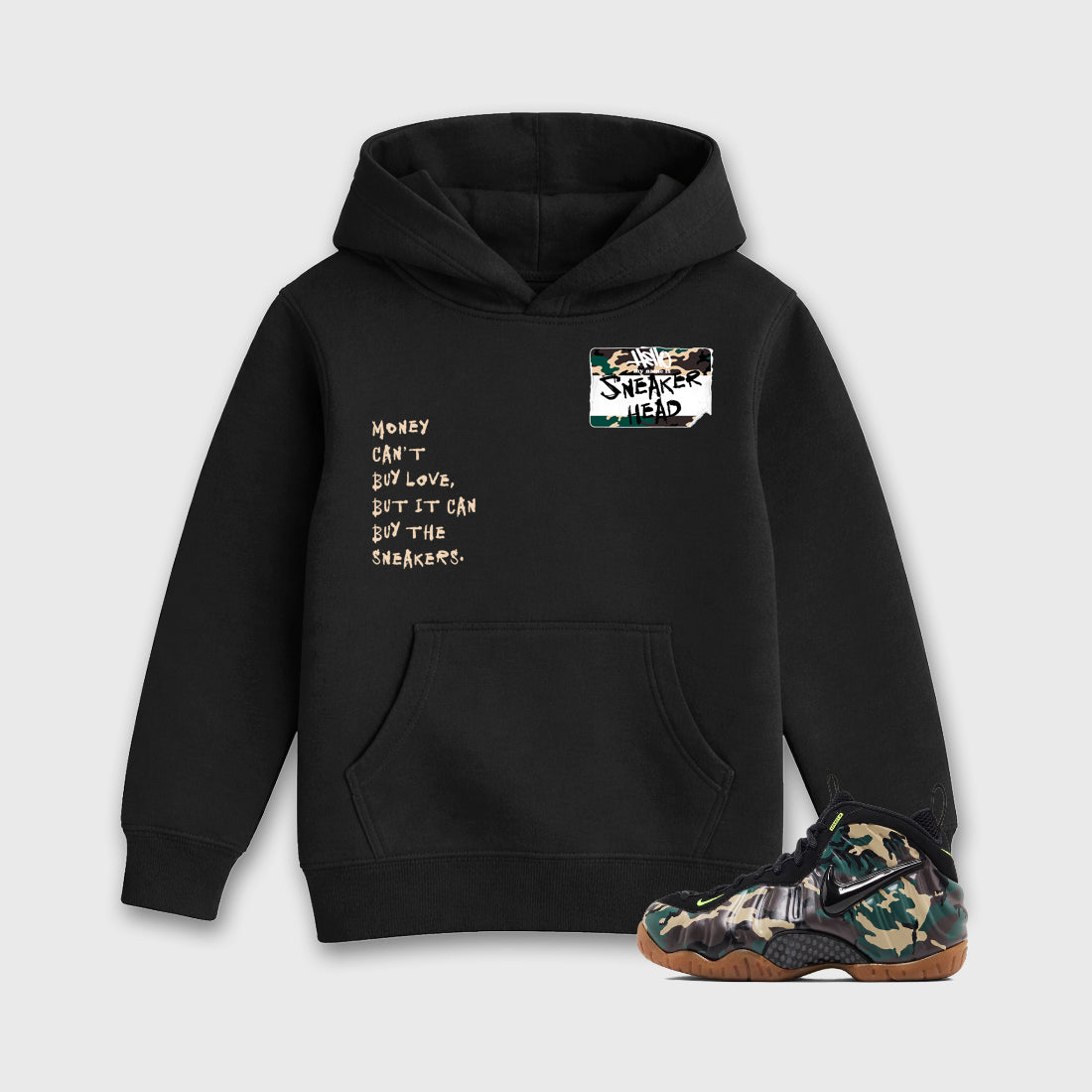 Sneakerhead Badge Baby & Kids Graphic Hoodie featuring original artwork designed to match the Air Foamposite Pro Green Camo. Black 1 Kids Graphic Sweater.