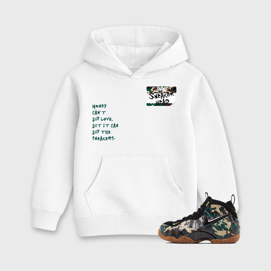 Sneakerhead Badge Baby & Kids Graphic Hoodie featuring original artwork designed to match the Air Foamposite Pro Green Camo. White 1 Kids Graphic Sweater.