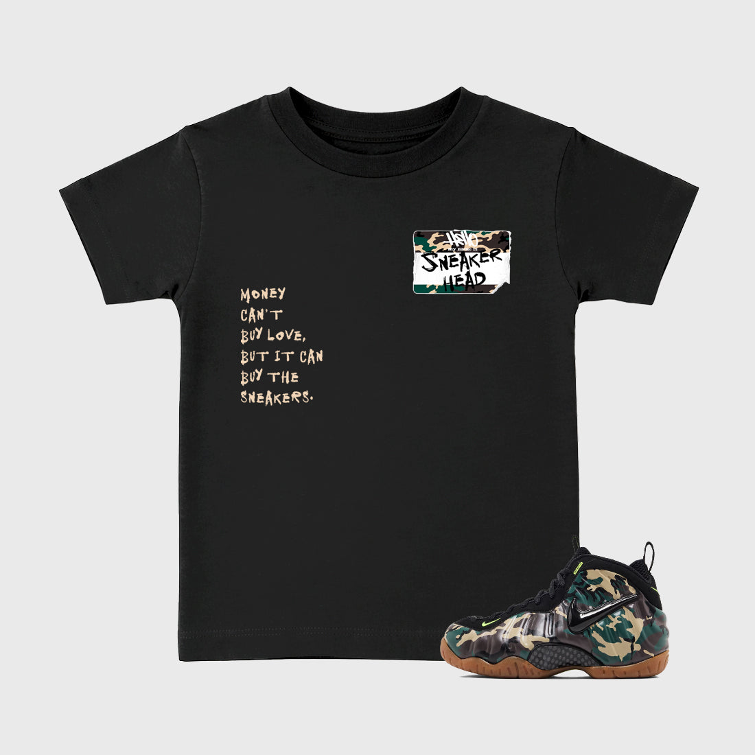 Sneakerhead Badge Baby & Kids Graphic T-Shirt featuring original artwork designed to match the Air Foamposite Pro Green Camo. Black 1 Kids Graphic Tee.