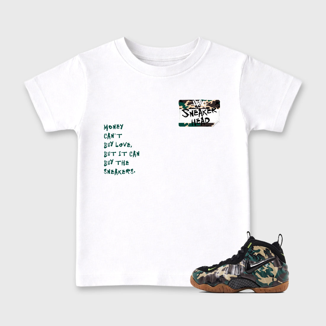 Sneakerhead Badge Baby & Kids Graphic T-Shirt featuring original artwork designed to match the Air Foamposite Pro Green Camo. White 1 Kids Graphic Tee.