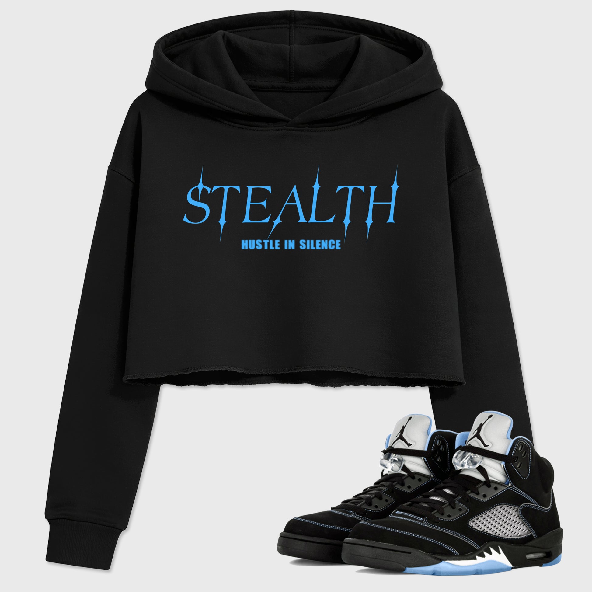 Stealth women’s crop tee designed to match the Air Jordan 5 Black Carolina, featuring coordinated Black 1 options for a perfect streetwear vibe.