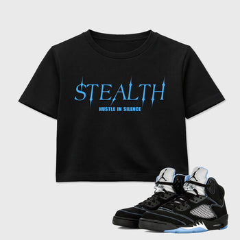 Stealth women’s crop tee designed to match the Air Jordan 5 Black Carolina, featuring coordinated Black 1 options for a perfect streetwear vibe.