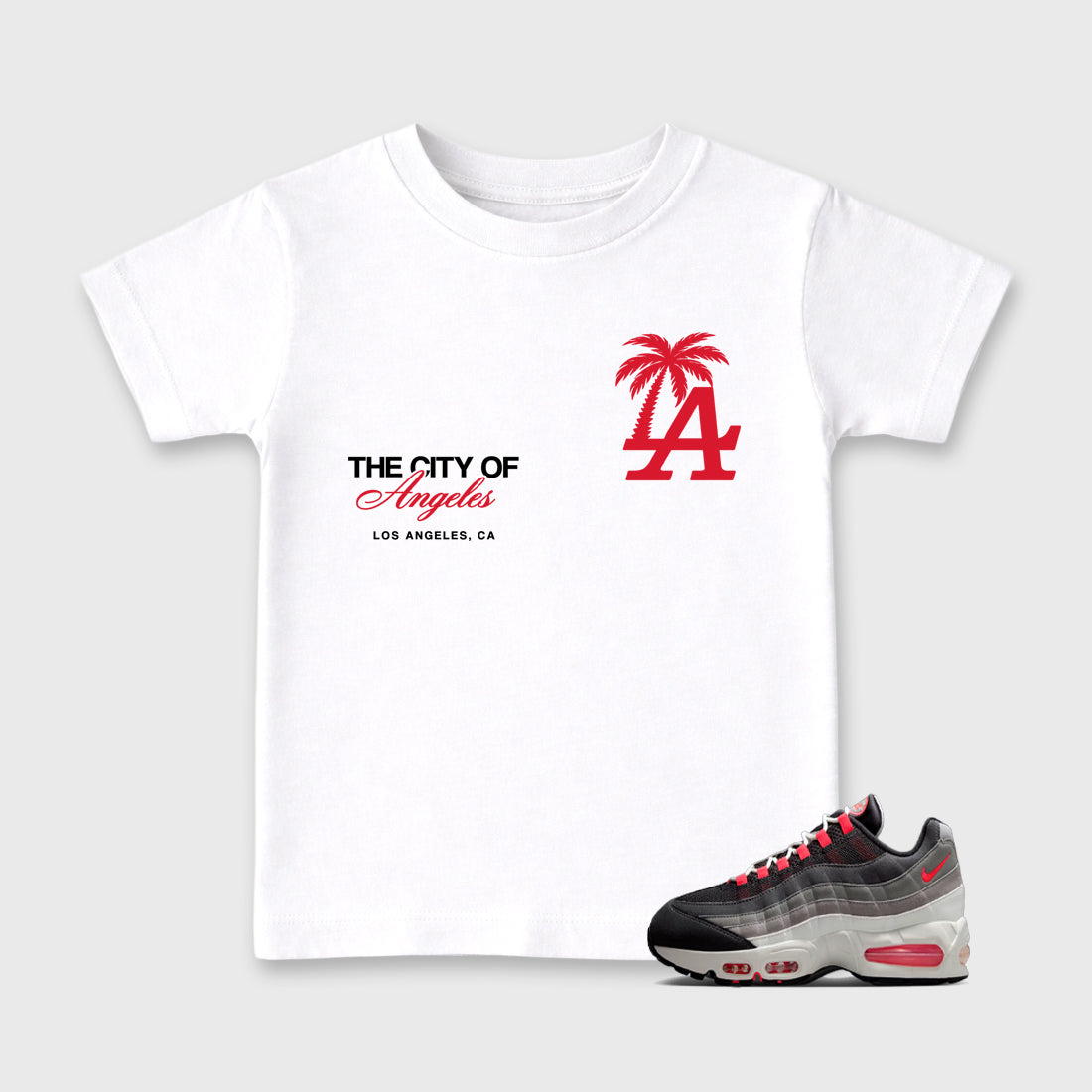 The City Of Angeles Baby & Kids Graphic T-Shirt featuring original artwork designed to match the Air Max 95 Reverse Solar Red. White 1 Kids Graphic Tee.