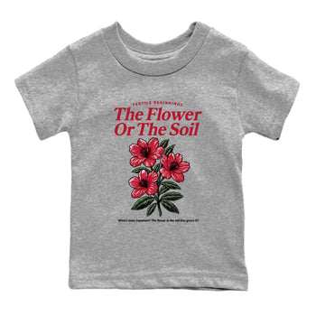 The Flower Or The Soil baby and kids t-shirt crafted for little sneakerheads to shine with the Air Jordan 1 Ruby sneakers, displayed in Heather Grey 2.