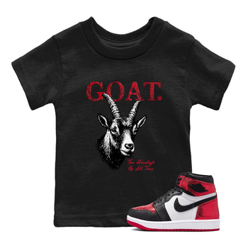 The Greatest Of All Time baby and kids t-shirt crafted for little sneakerheads to shine with the Air Jordan 1 Ruby sneakers, displayed in Black 1.