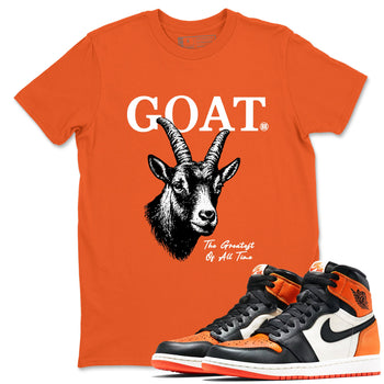 The Greatest Of All Time sneaker match t-shirt styled to complete your fit with the Air Jordan 1 Shattered Backboard sneakers, shown in Orange 1.