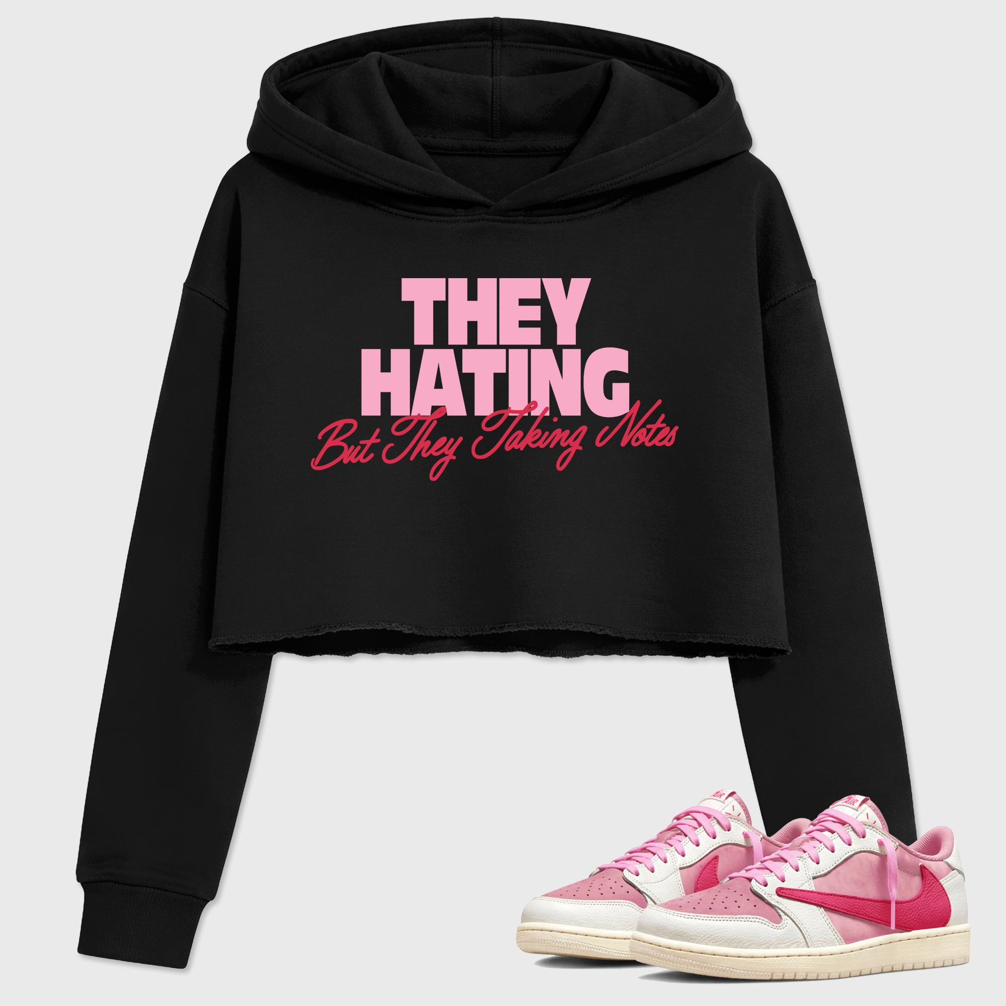 They Hating But Taking Notes women’s crop tee designed to match the Air Jordan 1 Travis Scott Tropical Pink, featuring coordinated Black 1 options for a perfect streetwear vibe.