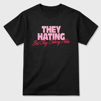 They Hating But Taking Notes Graphic T-Shirt sneaker match tee designed for the Air Jordan 1 Travis Scott Tropical Pink, featuring coordinated color options for a perfect streetwear match. Black 2 shirt.