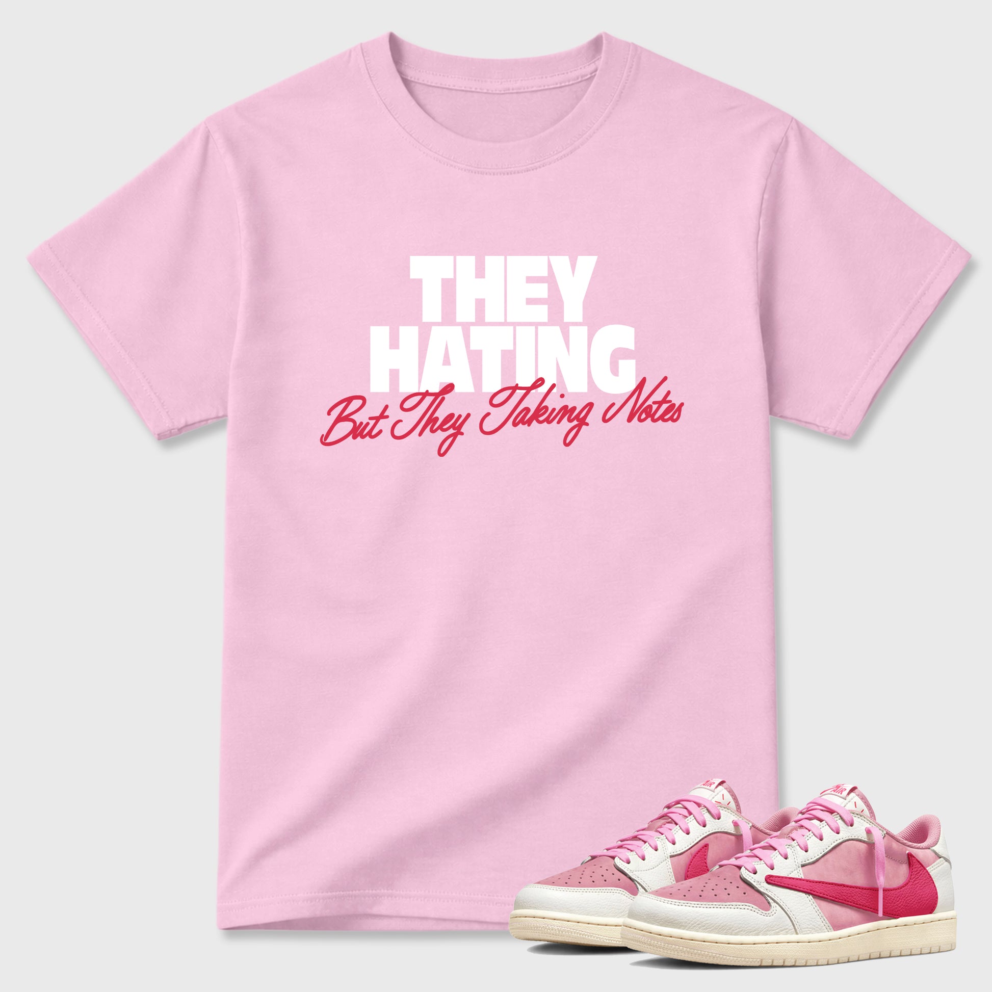 They Hating But Taking Notes Graphic T-Shirt sneaker match tee designed for the Air Jordan 1 Travis Scott Tropical Pink, featuring coordinated color options for a perfect streetwear match. Pink 1 shirt.