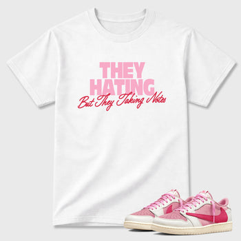 They Hating But Taking Notes Graphic T-Shirt sneaker match tee designed for the Air Jordan 1 Travis Scott Tropical Pink, featuring coordinated color options for a perfect streetwear match. White 1 shirt.