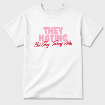 They Hating But Taking Notes Graphic T-Shirt sneaker match tee designed for the Air Jordan 1 Travis Scott Tropical Pink, featuring coordinated color options for a perfect streetwear match. White 2 shirt.