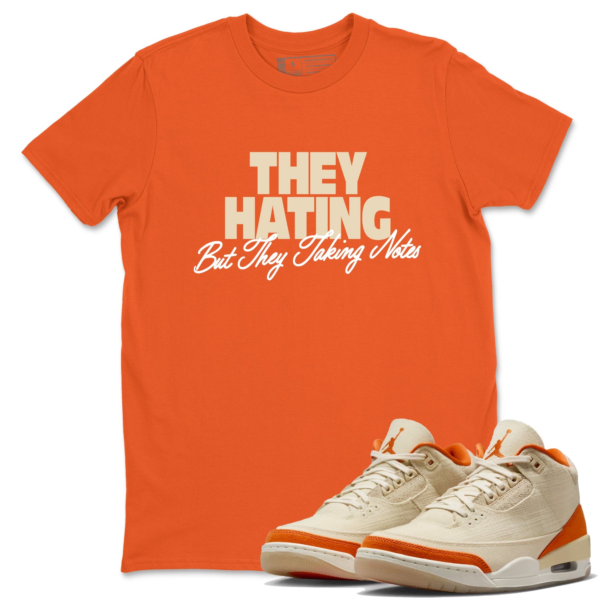 They Hating But Taking Notes sneaker match t-shirt styled to complete your fit with the Air Jordan 3 Starfish sneakers, shown in Orange 1.