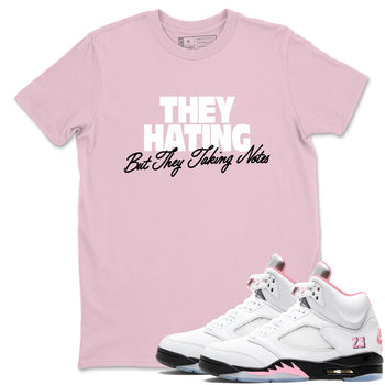 They Hating But Taking Notes sneaker match t-shirt styled to complete your fit with the Air Jordan 5 35th Anniversary sneakers, shown in Pink 1.