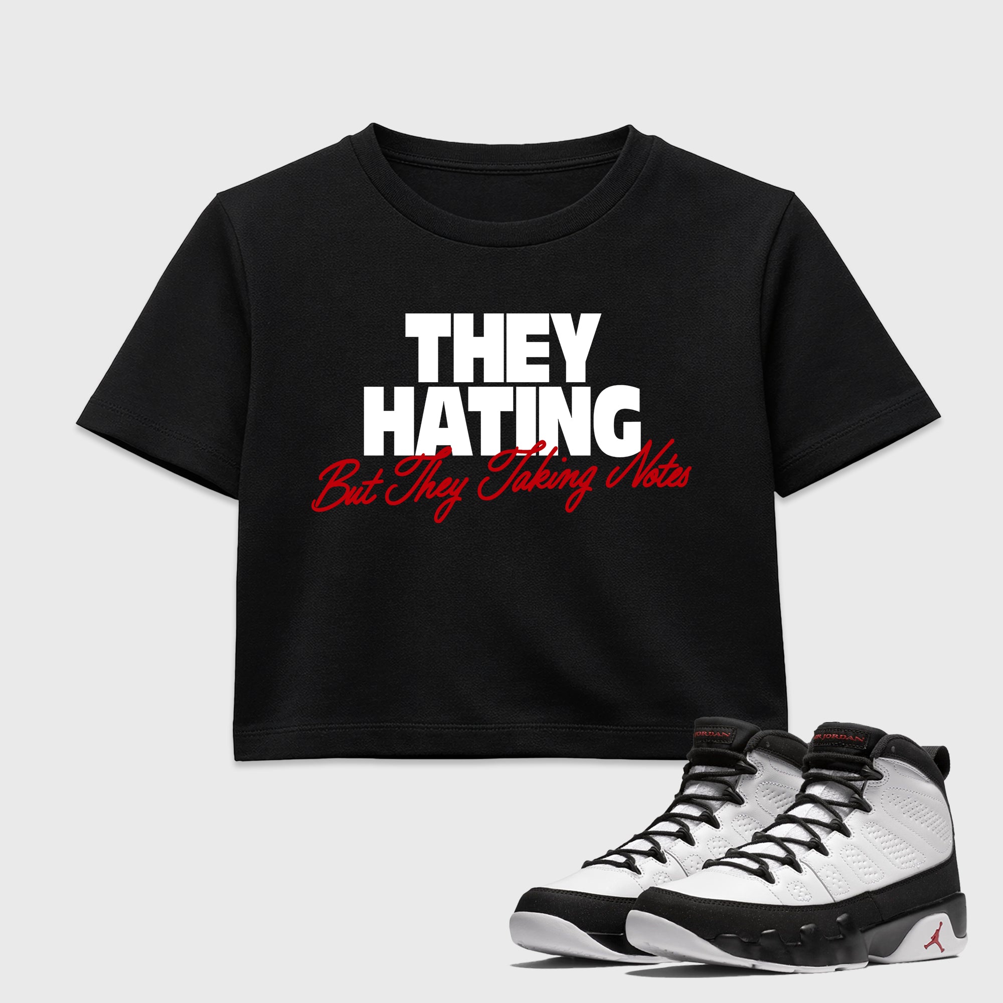 They Hating But Taking Notes women’s crop tee designed to match the Air Jordan 9 True Red, featuring coordinated Black 1 options for a perfect streetwear vibe.