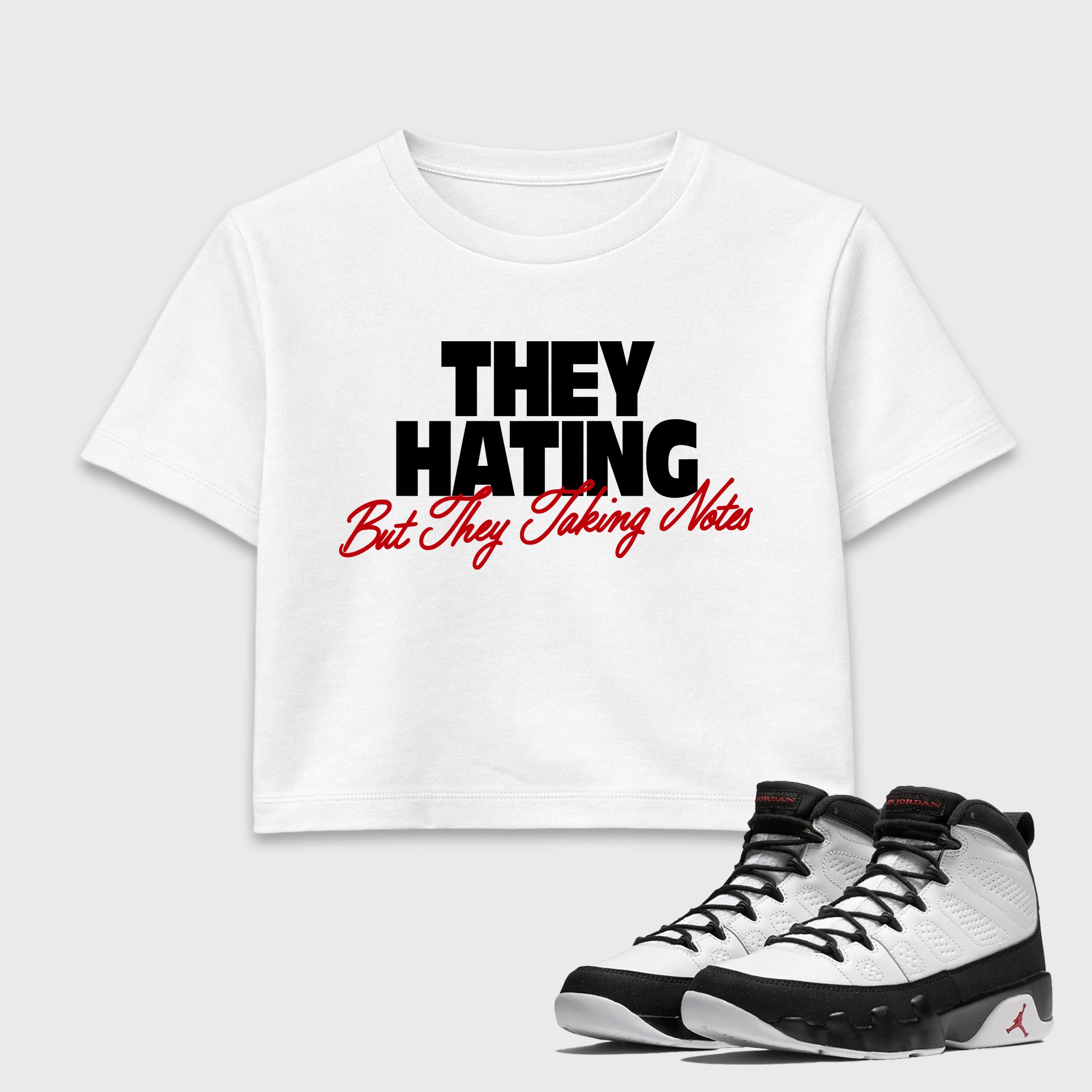 They Hating But Taking Notes women’s crop tee designed to match the Air Jordan 9 True Red, featuring coordinated White 1 options for a perfect streetwear vibe.